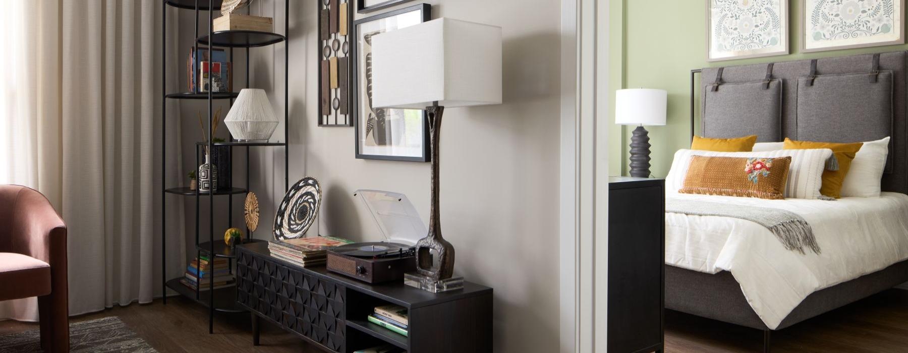 a bedroom with a bed and a shelf with books