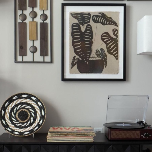 a black and white room with a black shelf and a lamp
