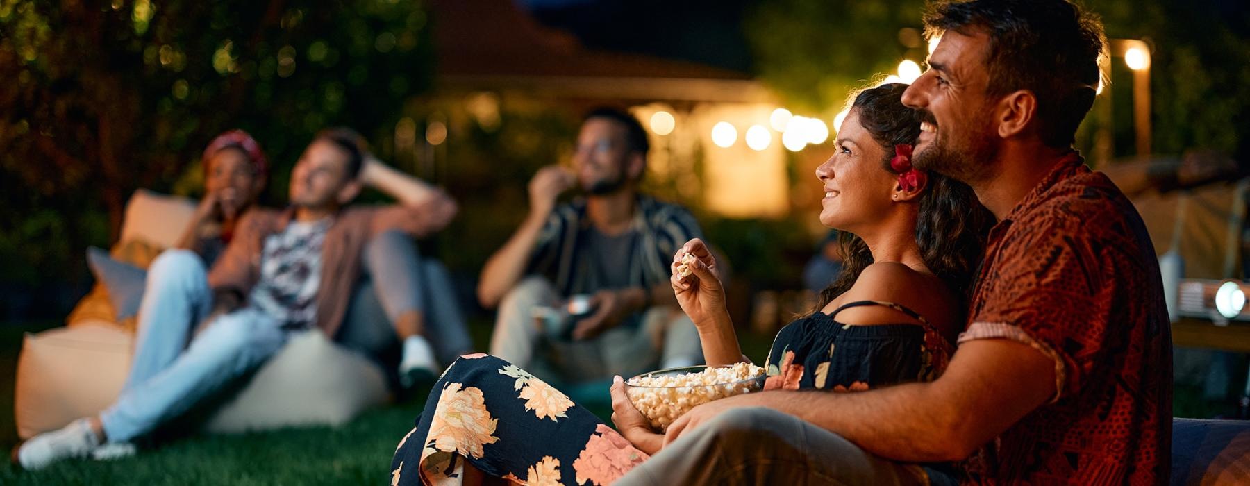 a group of people sitting on the grass